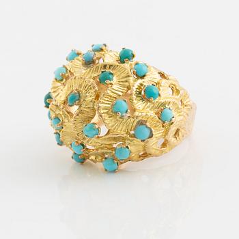 A 14K gold ring set with turquoises.