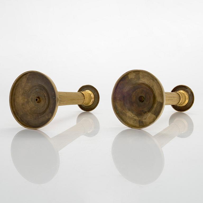 A pair of French gilded Empire candlesticks, early 19th century.