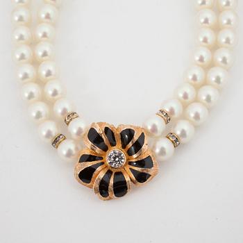 CHRISTIAN DIOR, a necklace with white decorativ perals and flowershaped clip earings in gold colored metal.