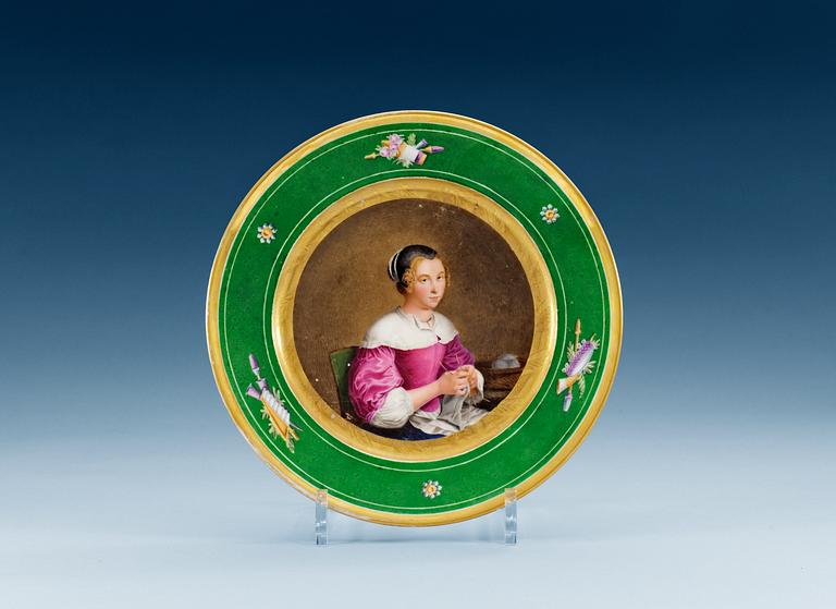 A french plate with a portrait of a young lady, 19th Century.