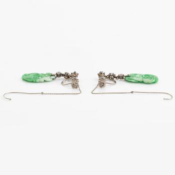 A pair of 18K white gold earrings with carved jadeite set with old-cut diamonds.