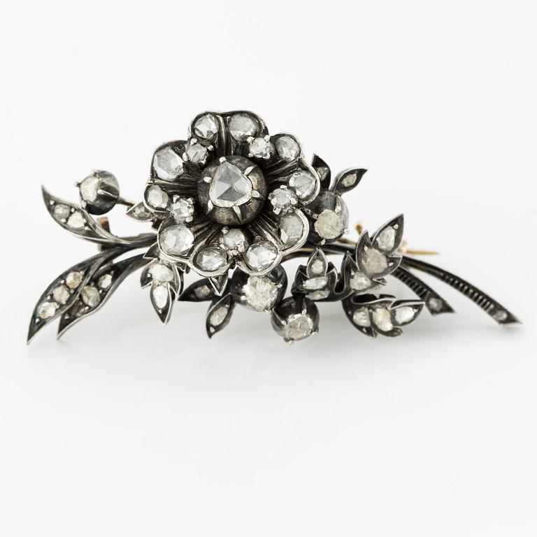 Brooch, in the shape of a floral sprig, silver with rose-cut diamonds.