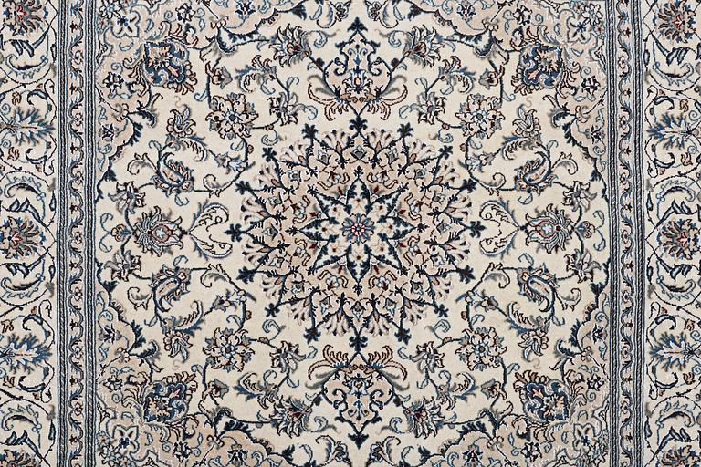 A rug, Nain, part silk, 9 laa, c. 202 x 199 cm.