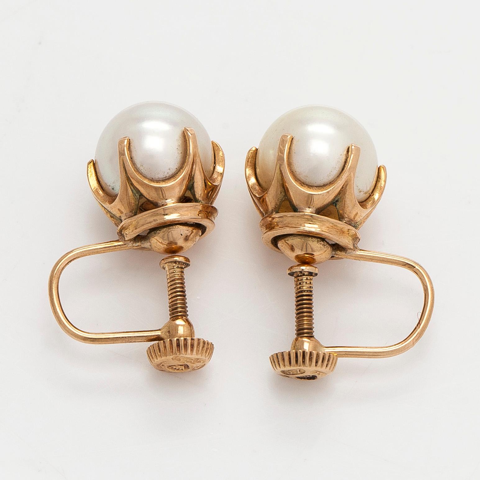 A pair of 14K gold earrings with cultured pearls.