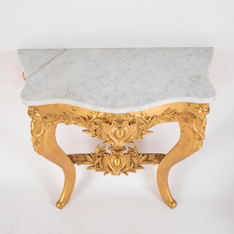 A mirror and console table from around the year 1900.