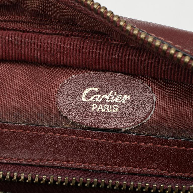 CARTIER, a red suede and leather bag.