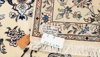 A Nain, part silk carpet, c. 337 x 244 cm.