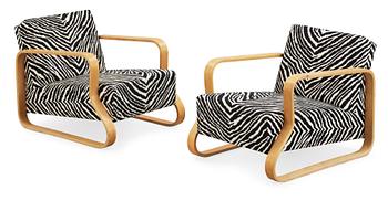 A pair of Alvar Aalto 'Padded Paimio' closed-framed armchairs, by O.y Huonekalu-ja Rakennustyötehdas A.B for Artek.