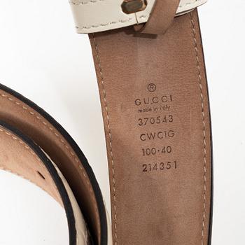 Gucci, wallet and belt.
