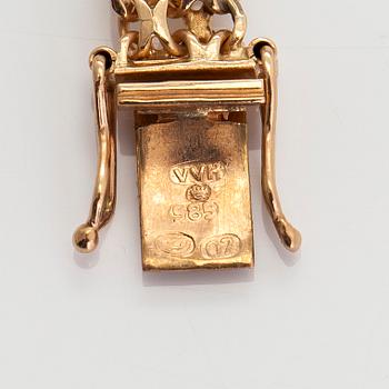 A 14K gold bracelet, x-link, with charms. Finnish import marks 1967.