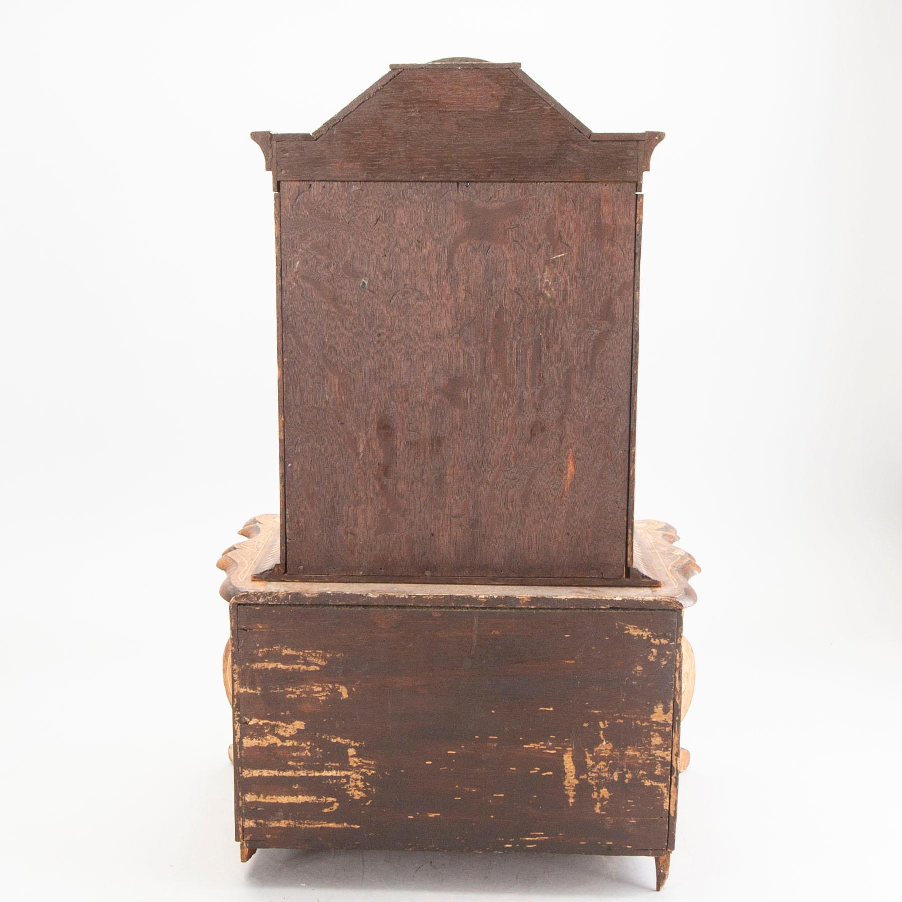 A Louis XV-style miniature cabinet around 1900.