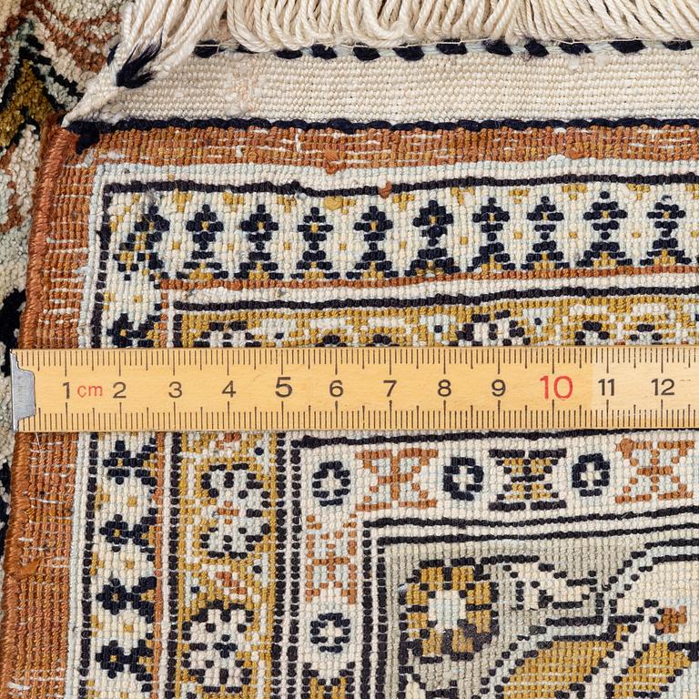 A Ghom, figural, silk rug, c. 205 x 140 cm.