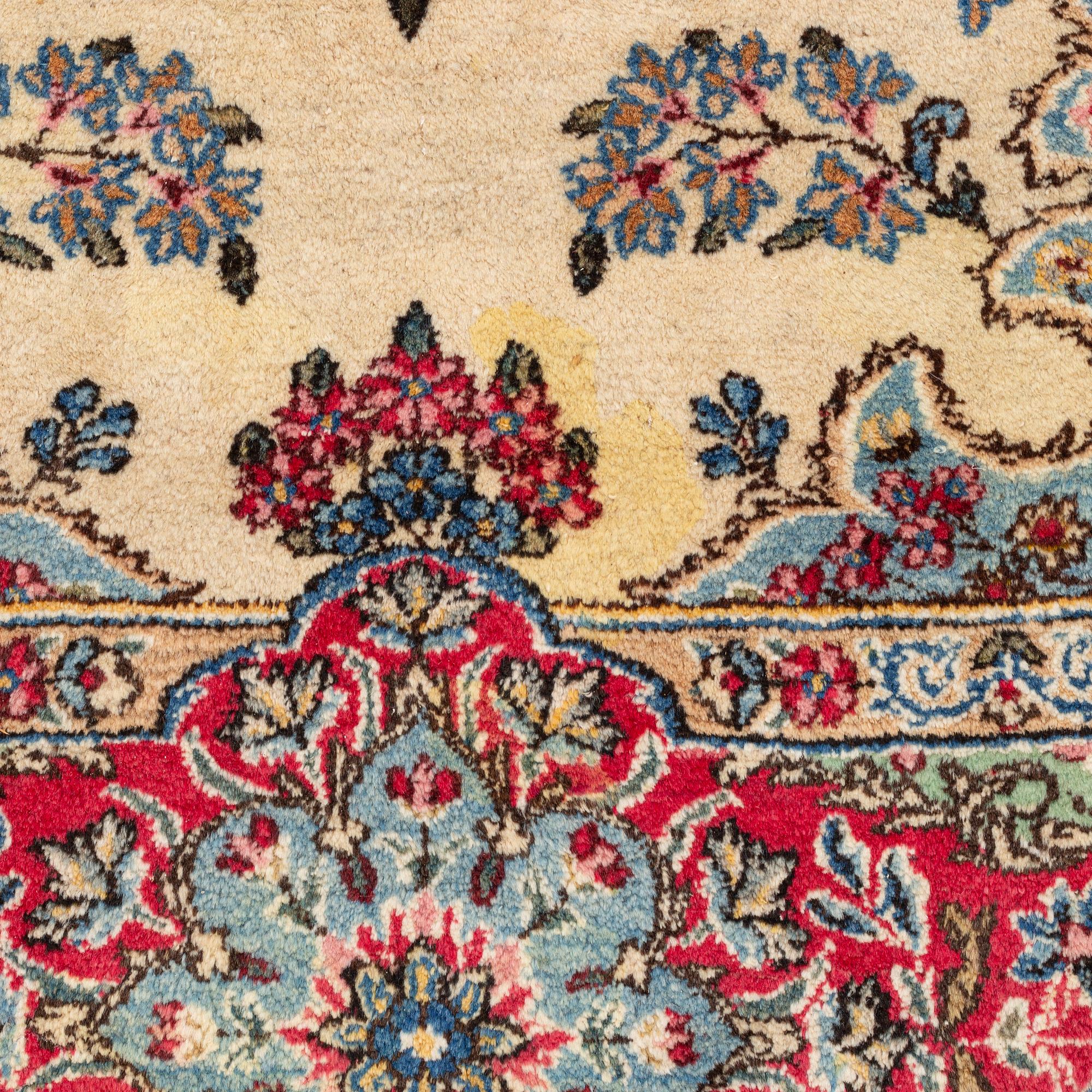 A carpet, old Kerman, approx. 314 x 210 cm.