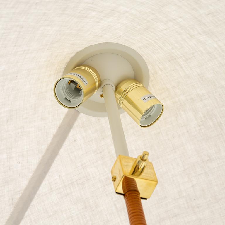Paavo Tynell, A model 9602 brass and rattan floor lamp with canvas shade from Gubi,
