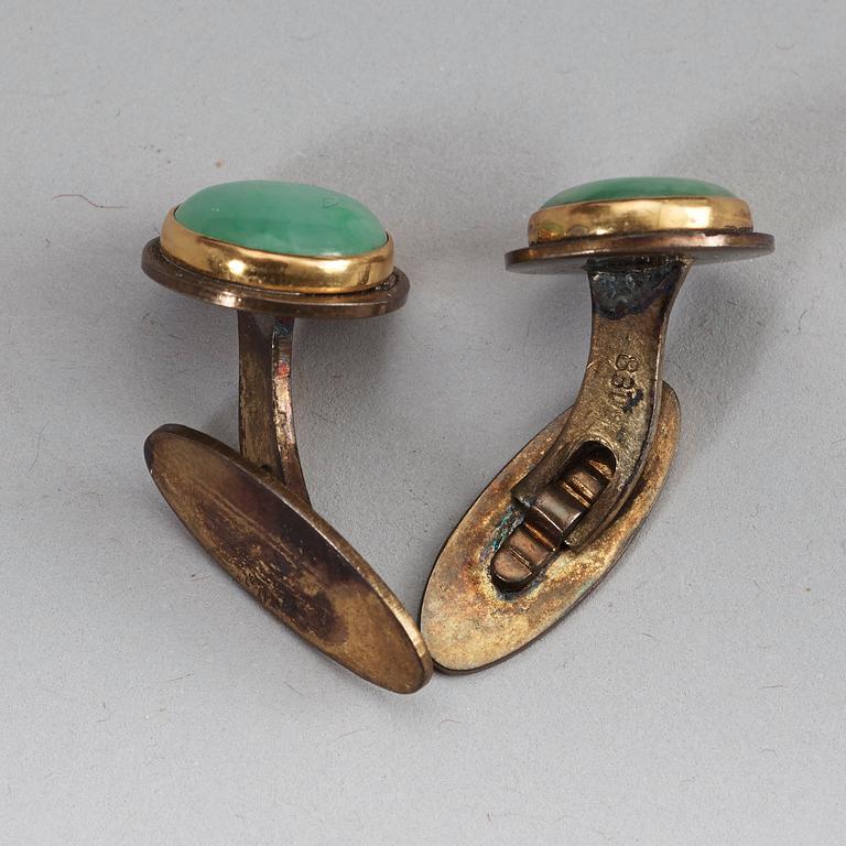 A pair of Chinese jadeite cufflinks mounted in partially goldplated silver, early 20th century.
