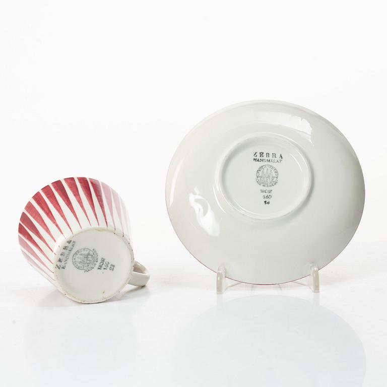 Eugen Trost, Three 'Red Zebra' cream-ware coffee cups on saucers, Uppsala-Ekeby Gefle.