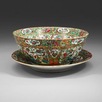 275. A famille rose Canton armorial punch bowl with stand, Qing dynasty, late 19th Century.