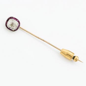 An 18K gold brooch pin with an old-cut diamond.