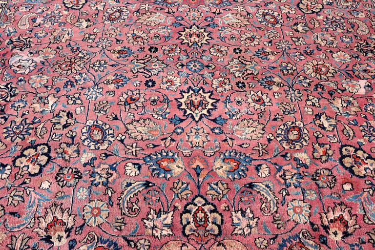 An antique Mashad carpet, signed Saber, c. 405 x 295 cm.