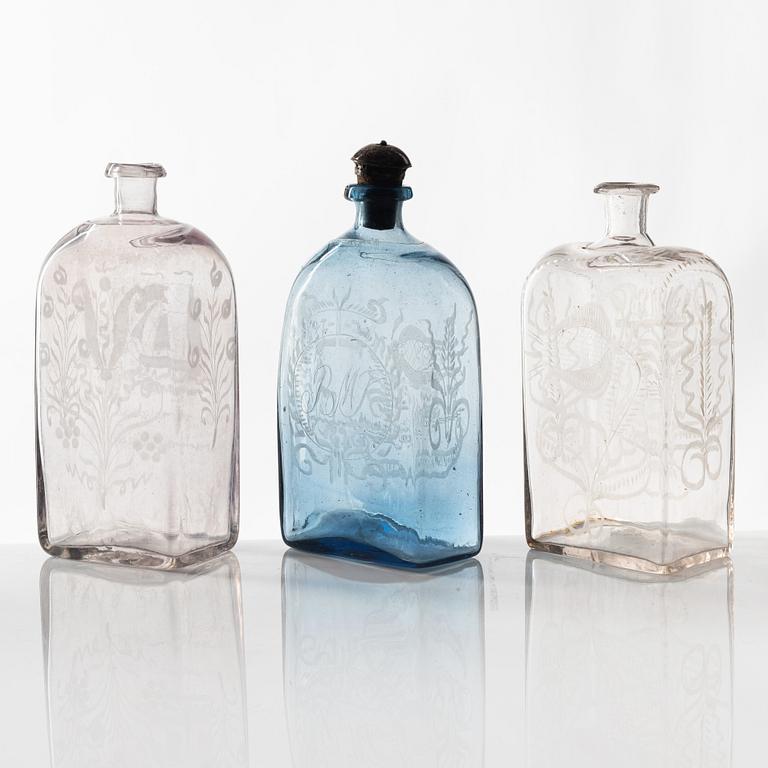 A set of three engraved brandy bottles, partly Cedersbergs glasbruk, 18th/19th century.