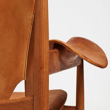 Finn Juhl, a teak and natural brown leather "Chieftain Chair" by Niels Vodder, 1950-60's.