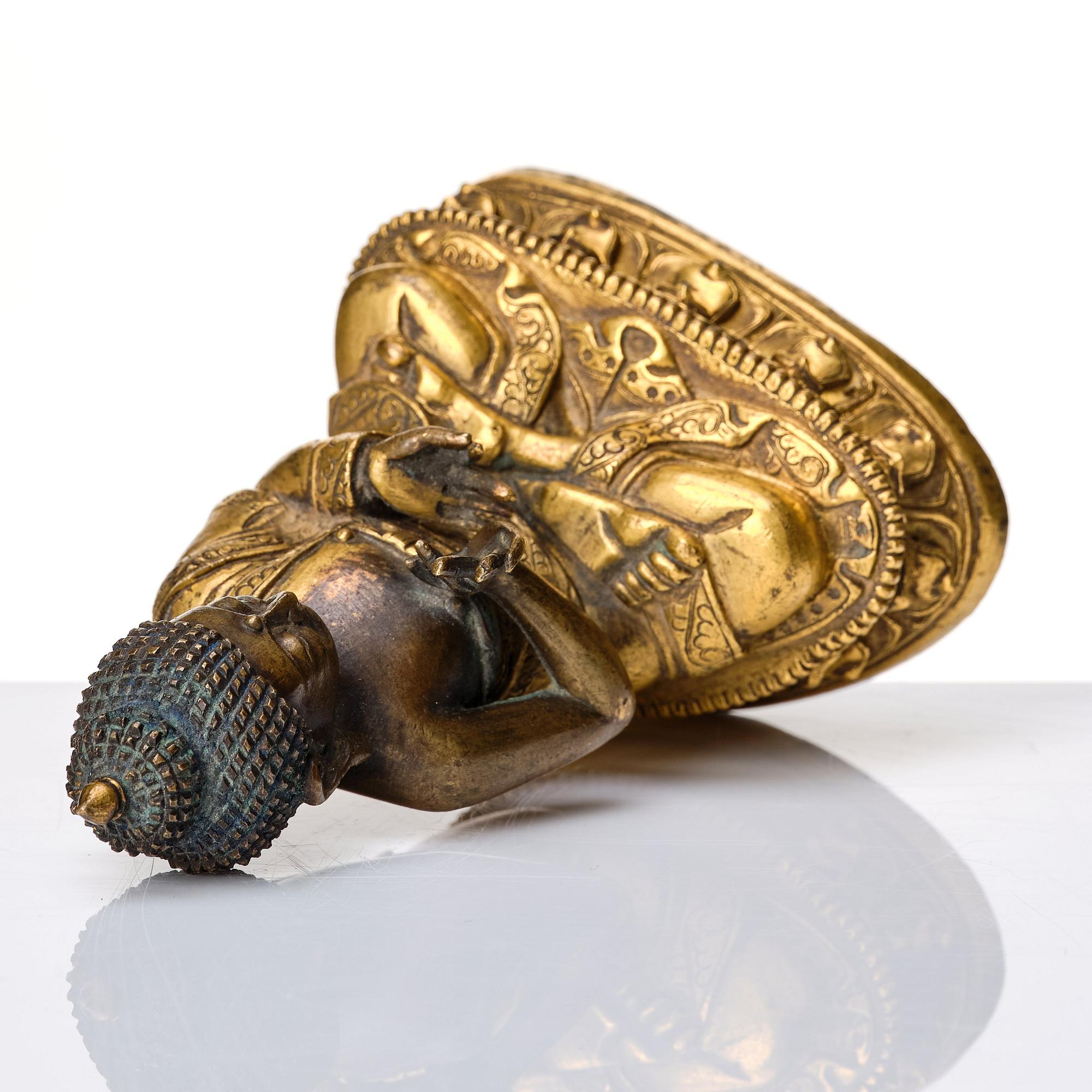 A partly gilt Tibeto-Chinese figure of Maitreya Buddha, 17th century.