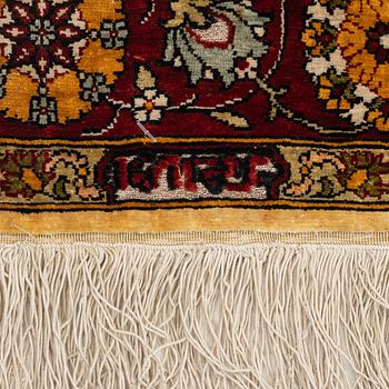 A silke rug, Hereke, signed, c. 90 x 61 cm.