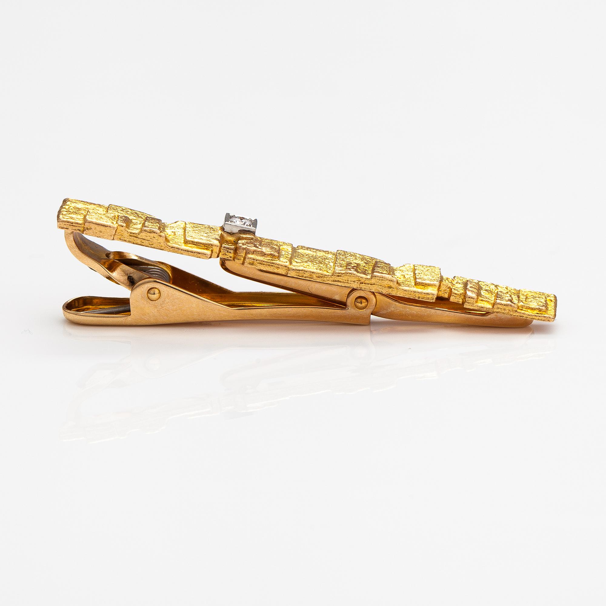 Björn Weckström, Solmioneula ja kalvosinnappipari "Jääriite", 14K kultaa, timantteja n. 0.18 ct yht. Lapponia.