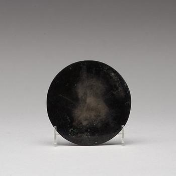 A bronze mirror, presumably Han dynasty (206 B.C - 220 A.D).