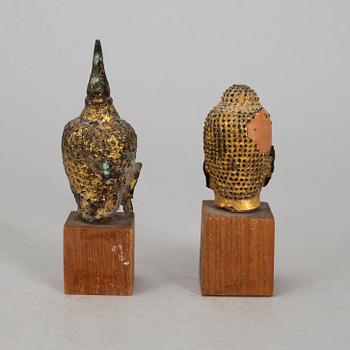 A group of two heads in wood and bronze, Thailand, Bangkok, circa 1900.