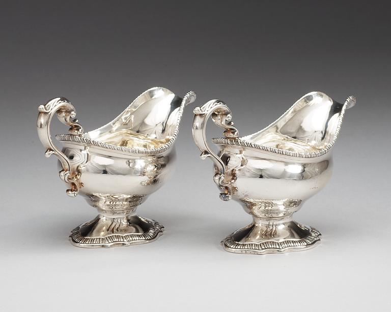 A pair of English 18th century silver sauce boats, makers mark of William Skeen, London 1766-1767.