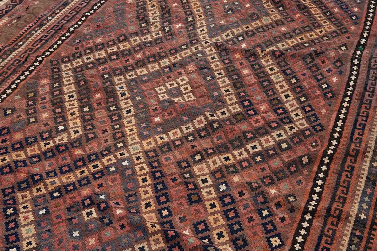 A semi-antique kilim carpet, a. 385 x 251 cm.