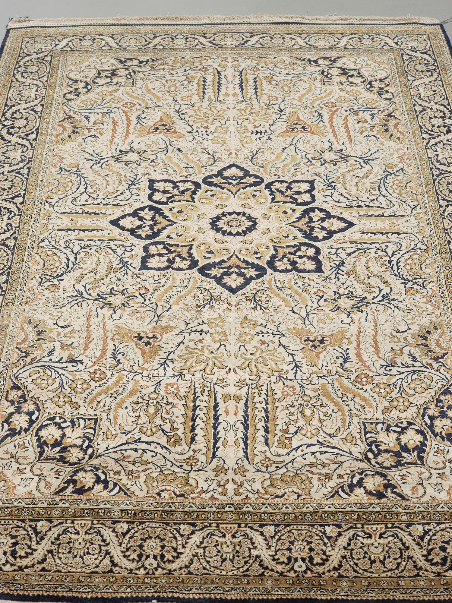 A silk Qum carpet, around  219 x 137 cm.