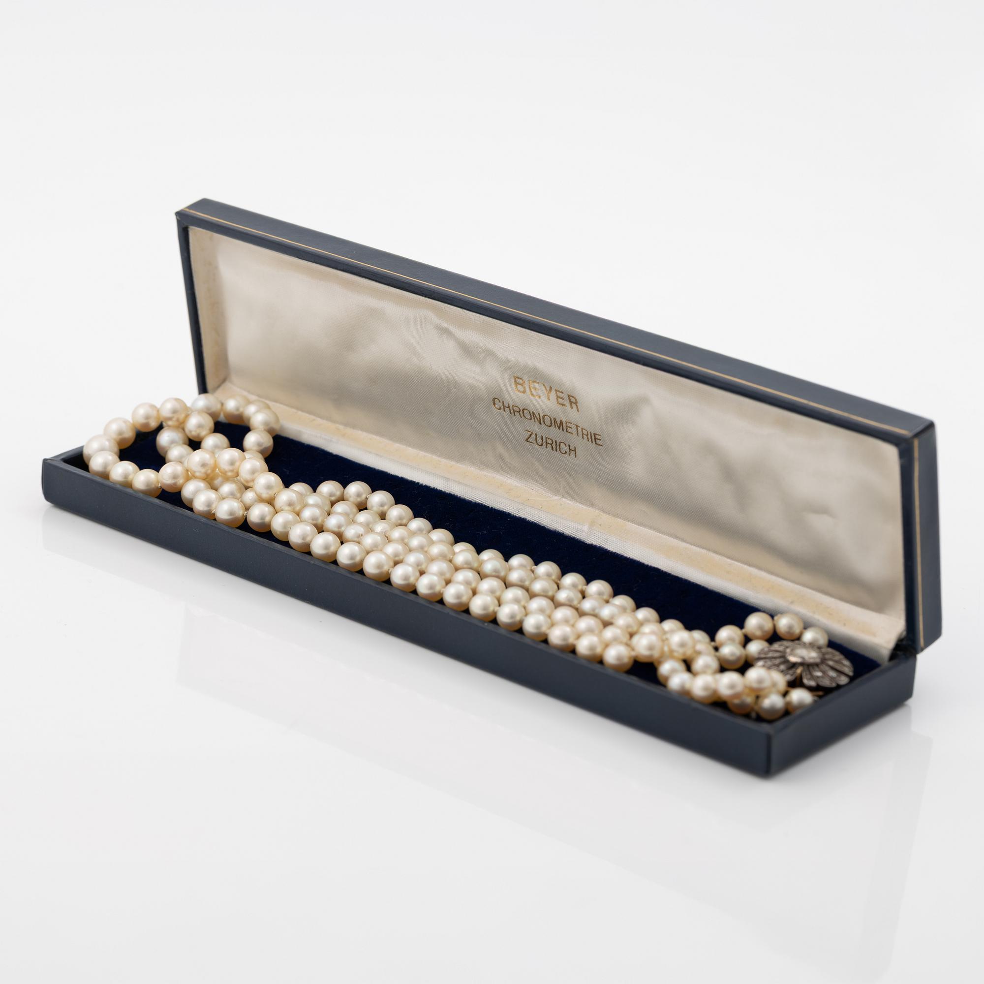 Two-row cultured pearl necklace with a silver and 18K gold clasp set with rose-cut diamonds.