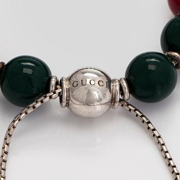Gucci, a 'Boule Britt"' bracelet.