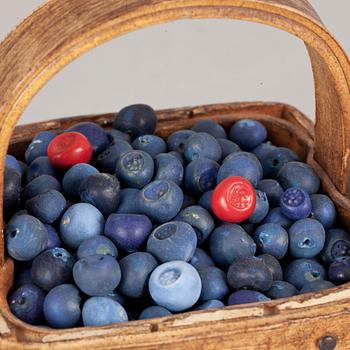 An Ingrid Herrlin stoneware blueberry basket with two lingonberries, Båstad, Sweden.