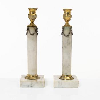 A pair of Gustavian brass and marble candlesticks, circa 1800.