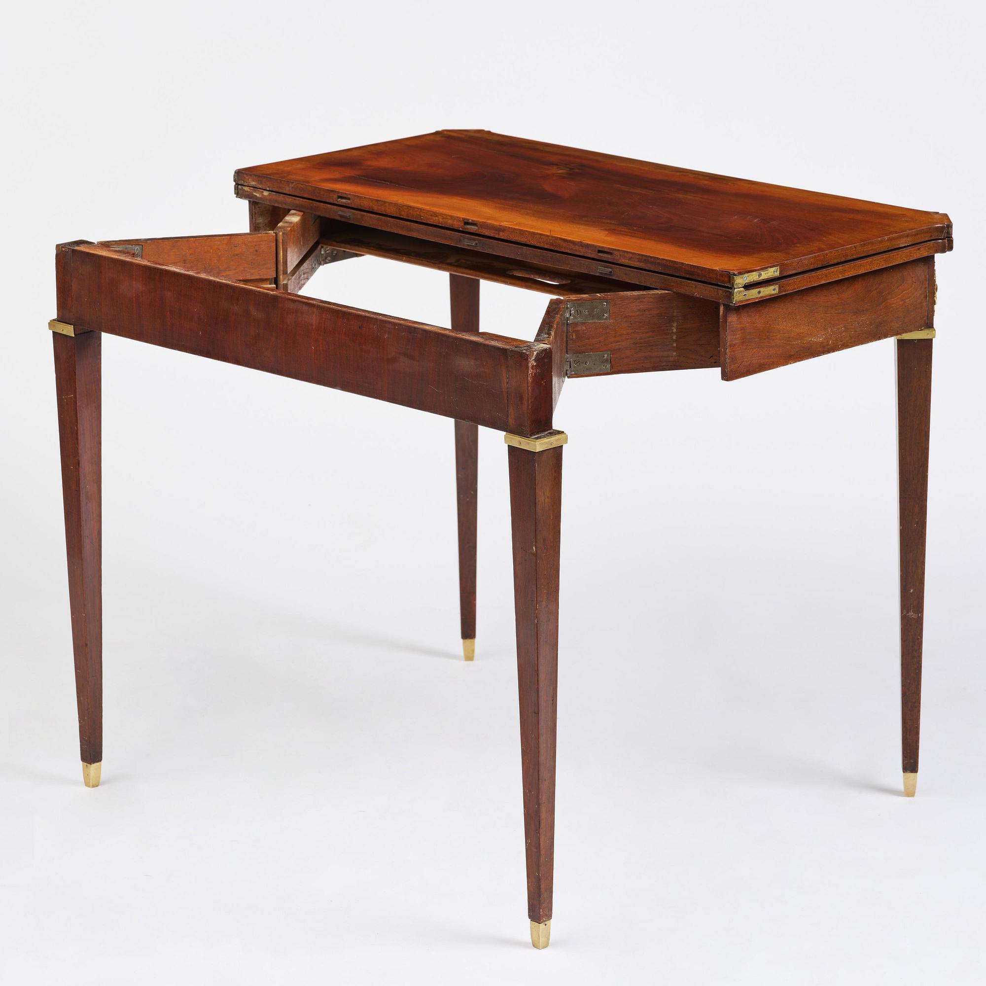 A Gustavian 'concertina action' mahogany games table by Georg Haupt (master in Stockholm 1770-84).
