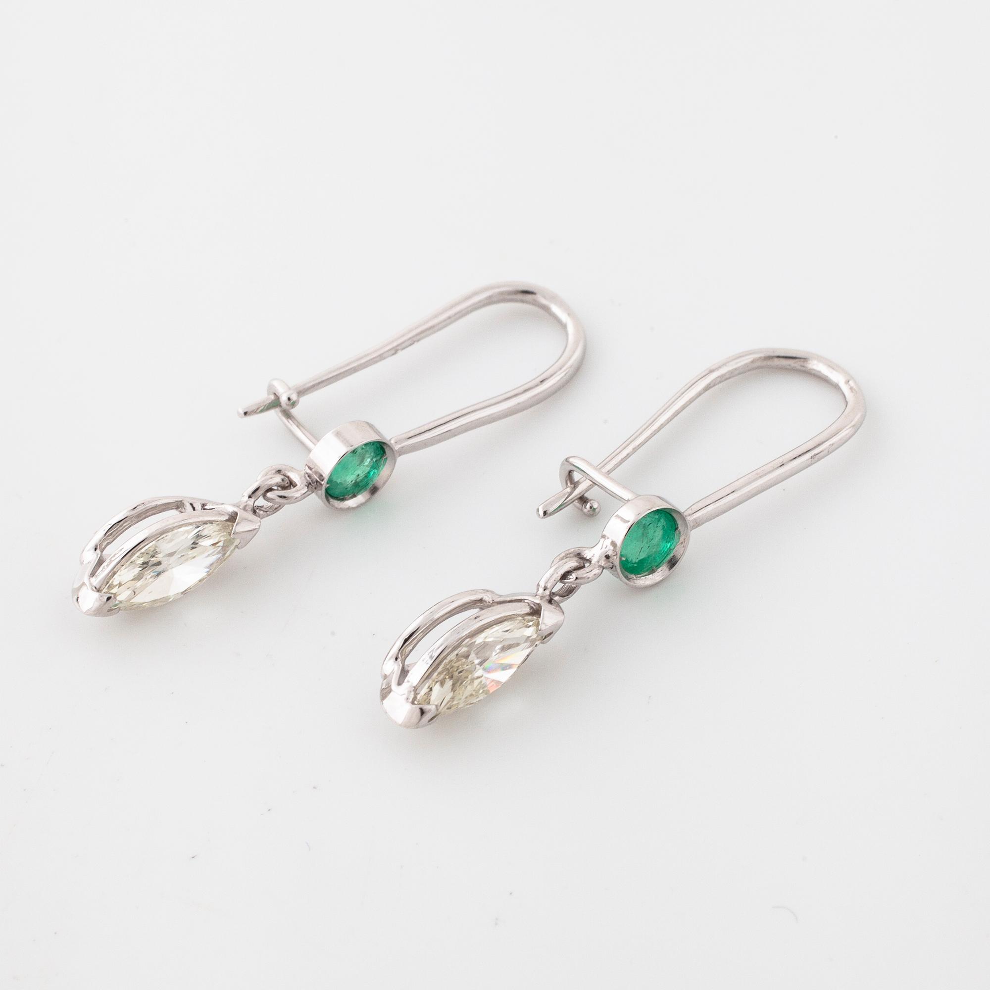 A pair of emerald and marquise cut diamond earrings.