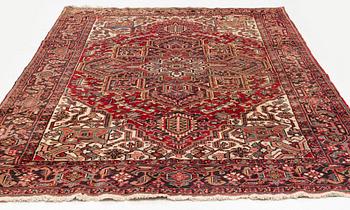An old Heris carpet, c. 315 x 225 cm.