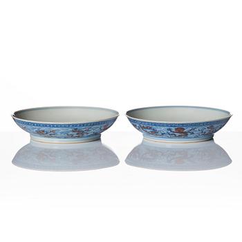 A pair of blue and white and iron red decorated dragon dishes, Qing dynasty with Qianlong mark.