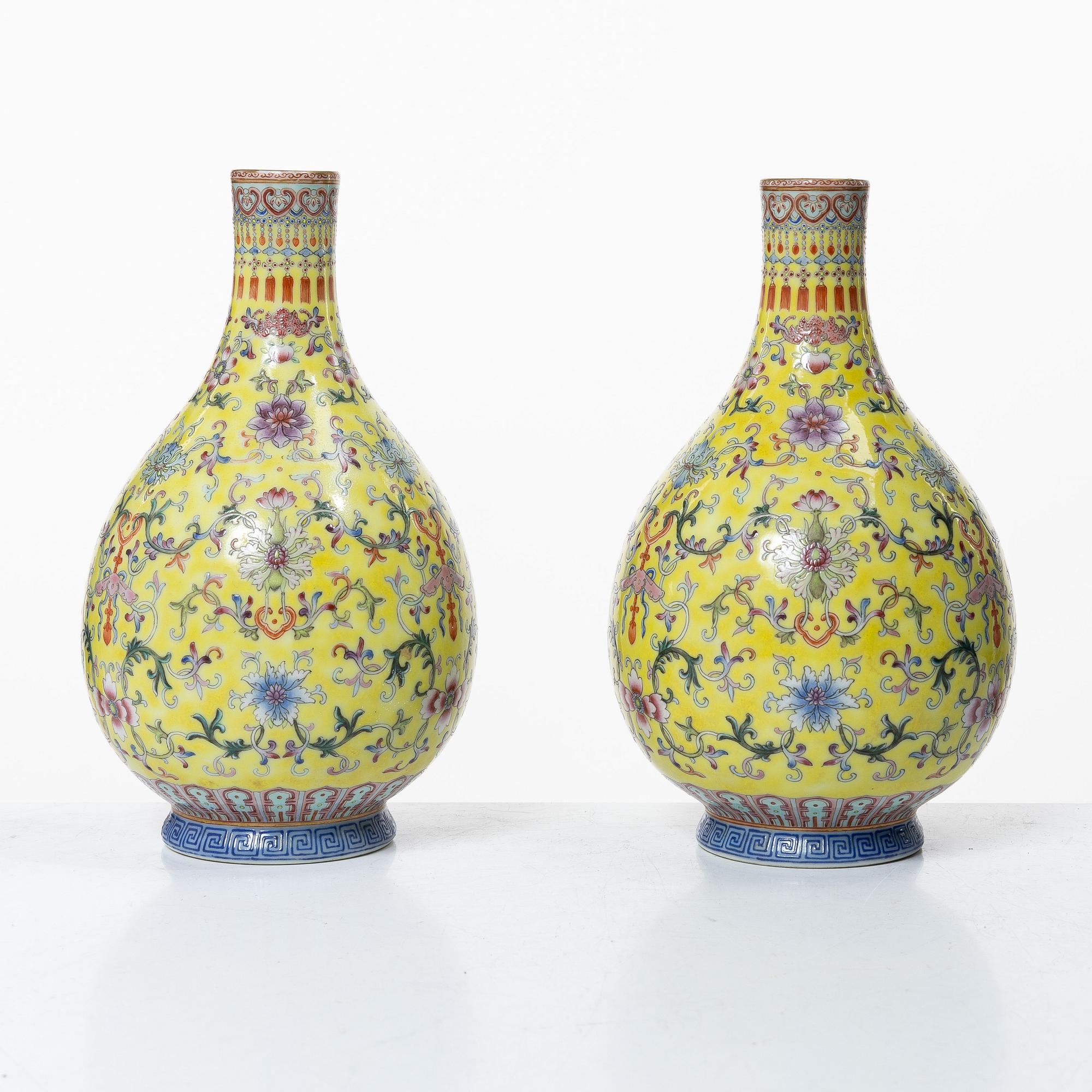 A pair of Chinese yellow ground porcelain vases, 1900s.