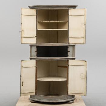 A first half of the 19th century painted corner cabinet.