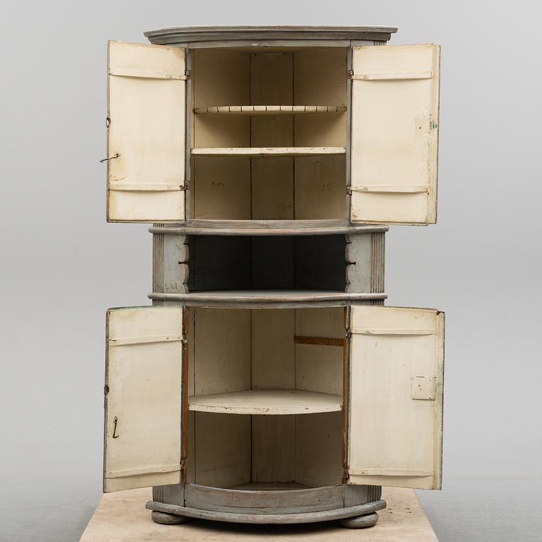 A first half of the 19th century painted corner cabinet.
