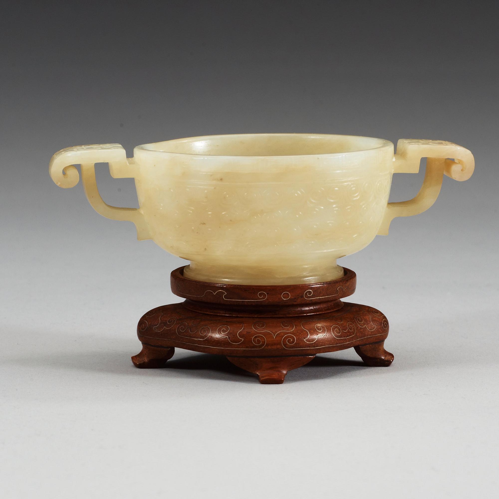 A carved nephrite cup, China.