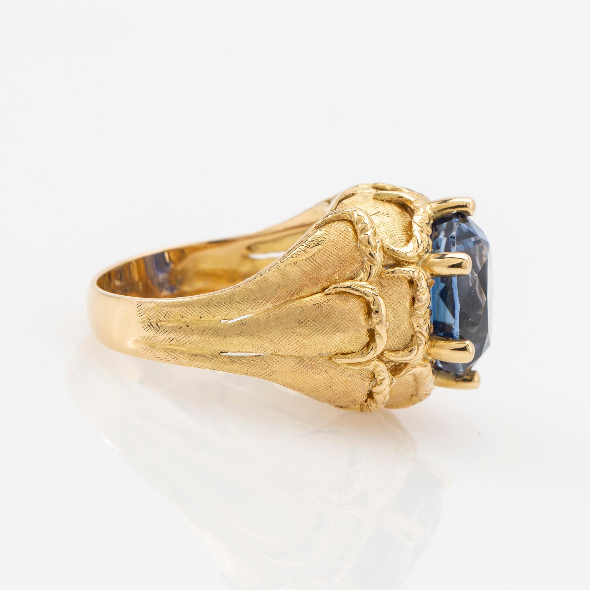 Ring, 18k gold with blue stone, possibly sapphire.