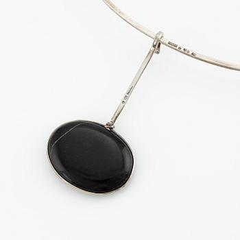 Vivianna Torun Bülow-Hübe, a pendant with chain, silver with a beach pebble, 1963.