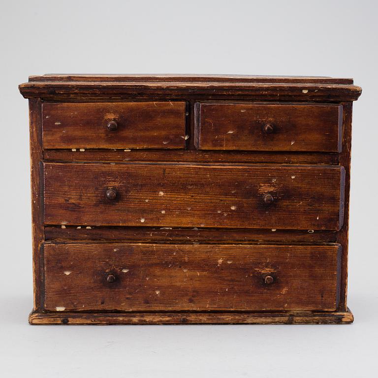 A 19th century miniature chest of drawers.