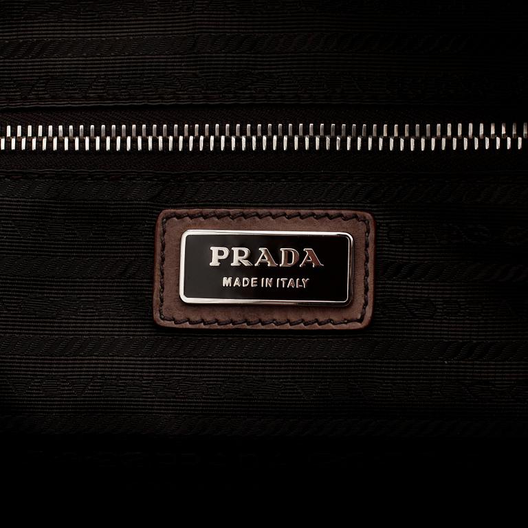 PRADA, a brown leather top handle bag.