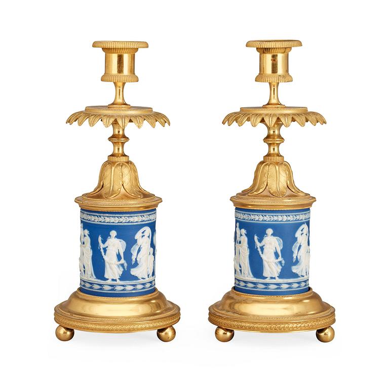 A pair of Victorian Wedgewood and gilt bronze candlesticks.
